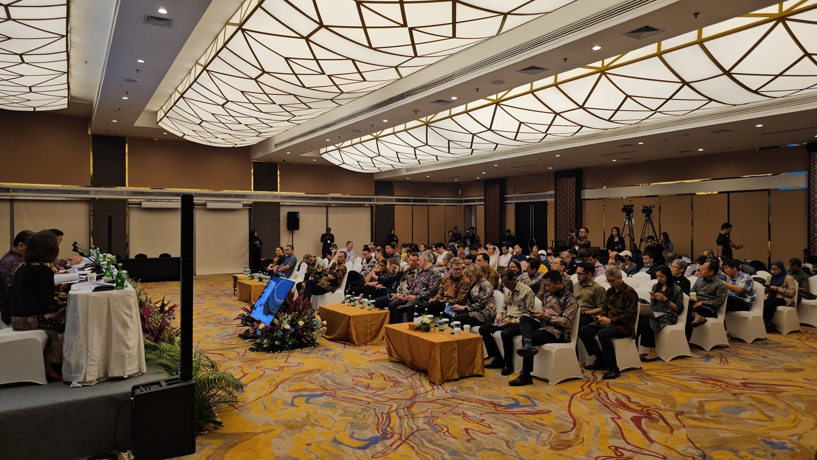 Professional press conference setup with media attendance