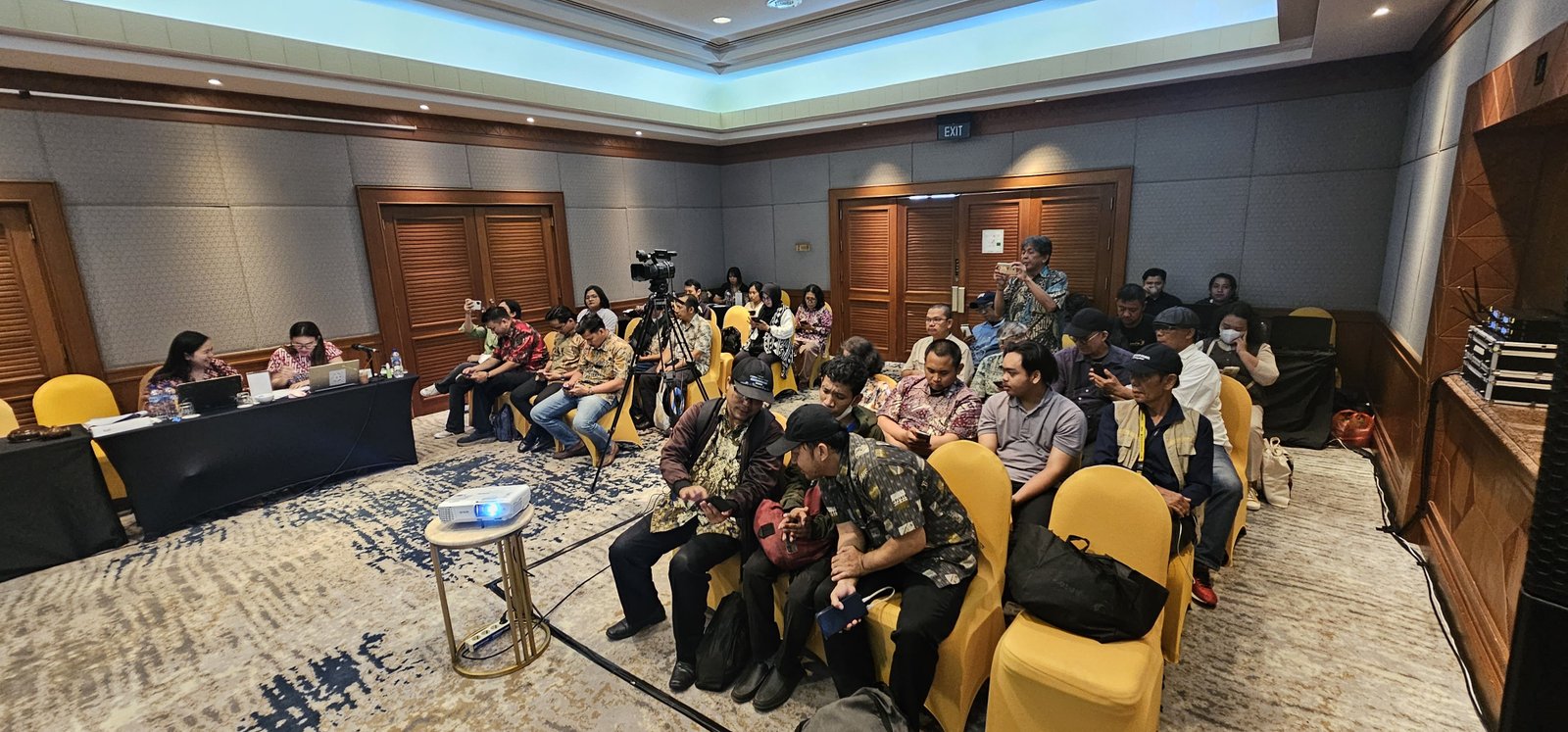 Corporate press conference with executive speakers and journalists